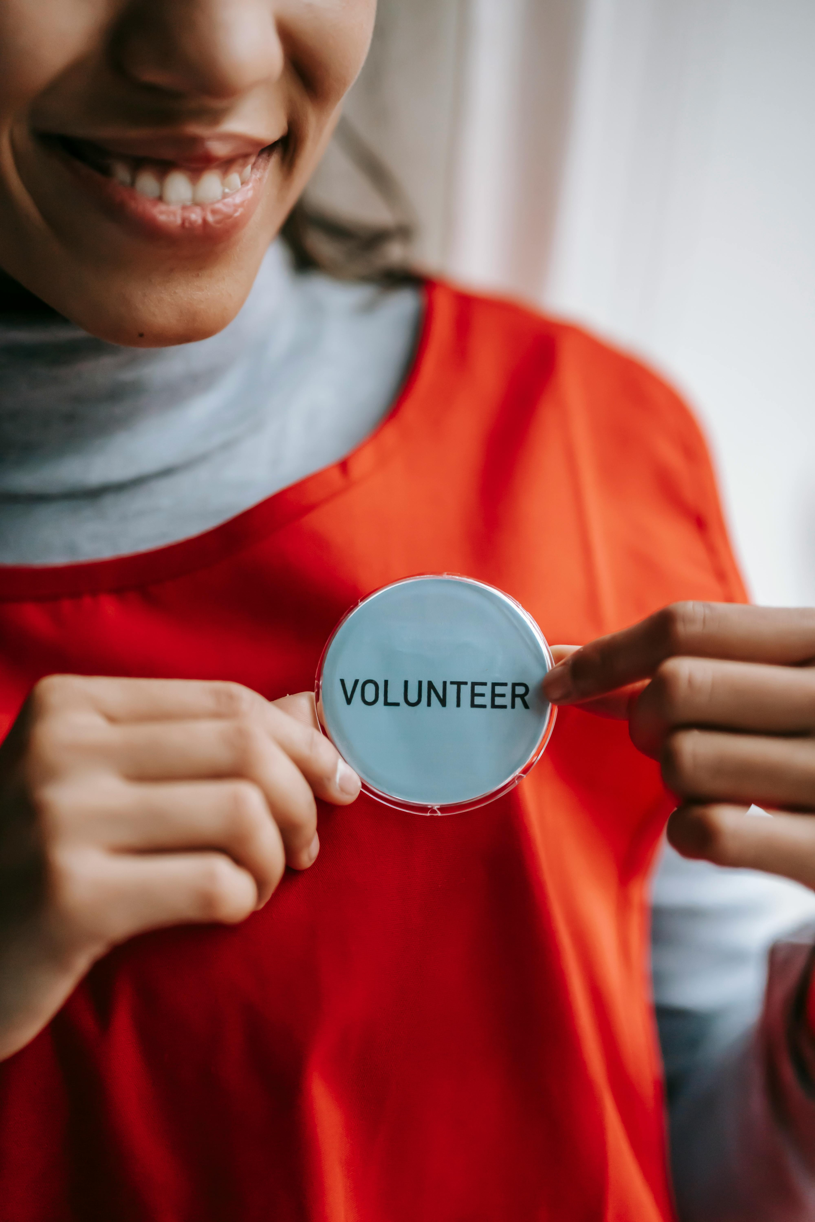 Volunteer holding badge